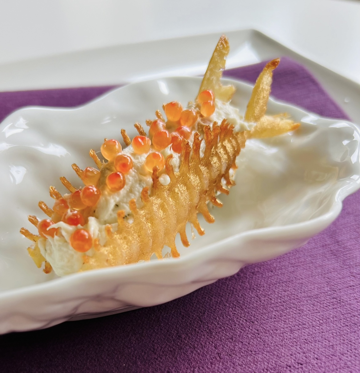 Golden fishbone amuse with smoked trout
