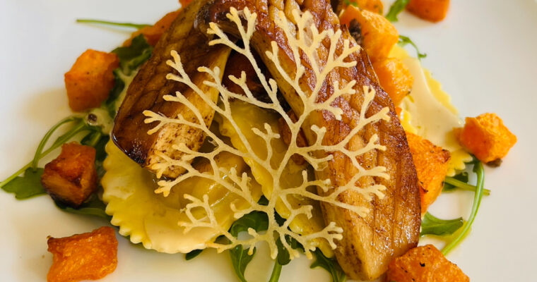 King bolete and madeira sauce on truffle ravioli and butternut squash