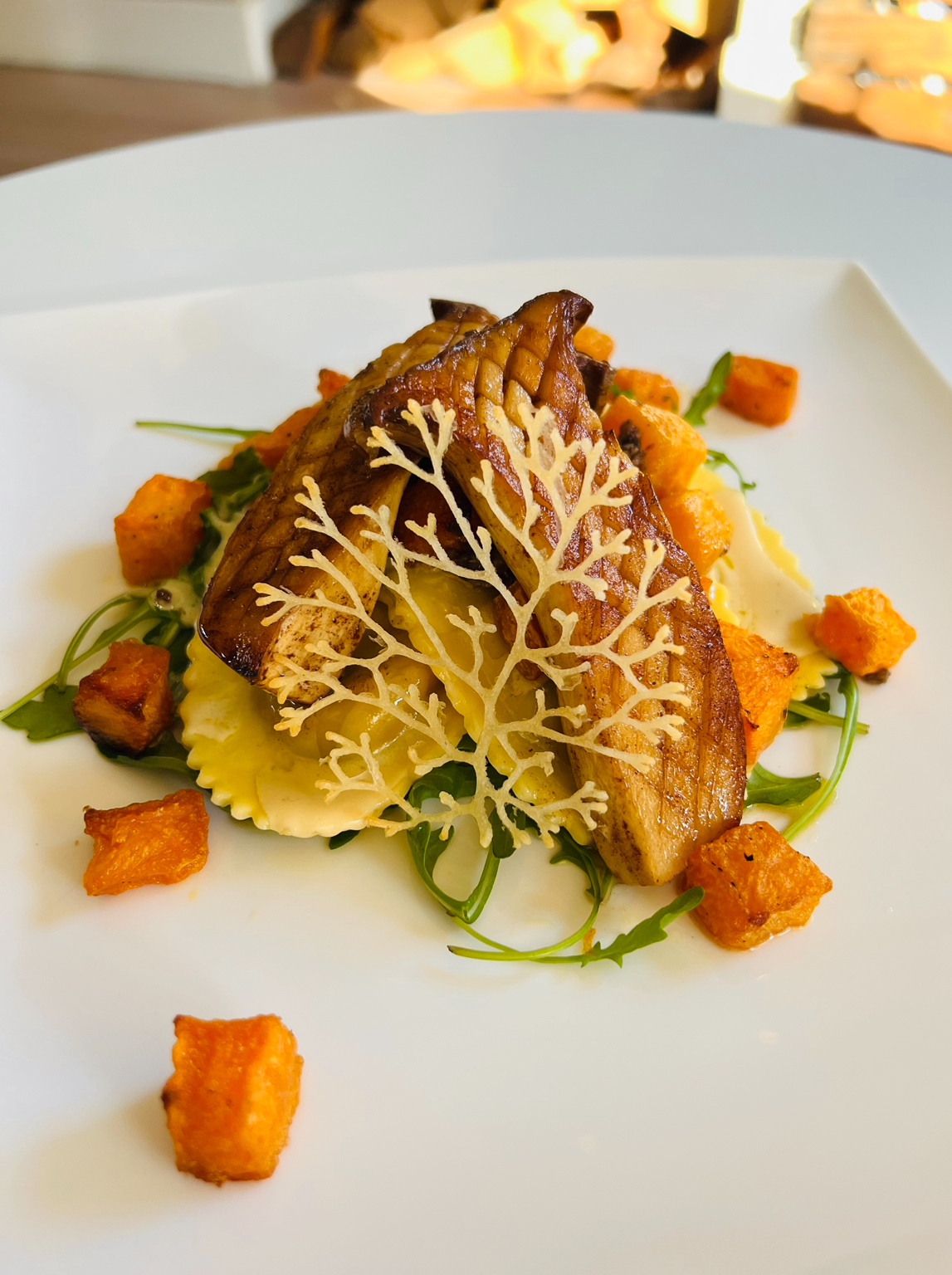 King bolete and madeira sauce on truffle ravioli and butternut squash